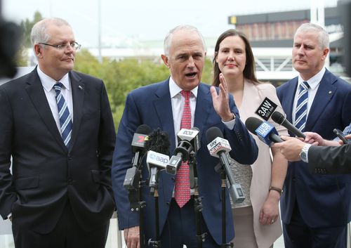 Prime Minister Malcolm Turnbull (centre) speaks to the media as Treasurer Scott Morrison (left) and Michael McCormack (right) look on during a press conference at Melbourne. (AAP)