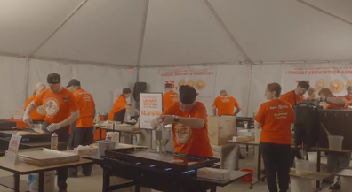 Chefs making pancakes at separate griddle stations.