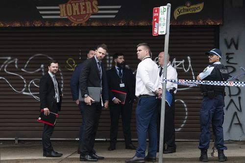 Two bodies have been found on Oxford St, Cambridge. Possible family members  of the victims are escorted by the police.November 30, 2024. Photo: Rhett Wyman / SMH