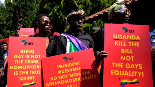  Activists hold placards during their picket against Uganda's anti-homosexuality bill at the Ugandan High Commission in Pretoria, South Africa