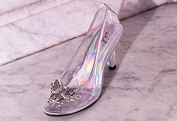 Who first introduced the glass slippers to the Cinderella story in an 1697 adaptation?