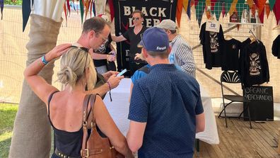 Damian Lewis signing albums in the merch tent at Black Deer Festival 2023