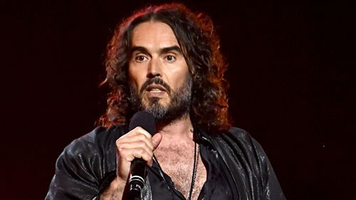 Russell Brand speaks onstage.