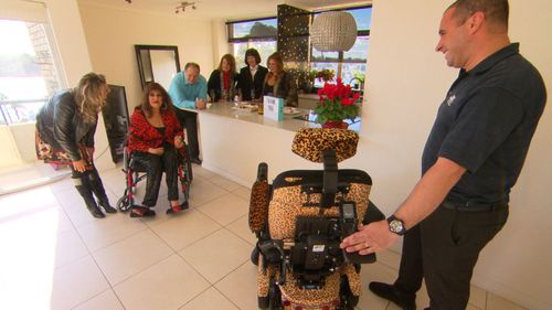 Maria is presented with a special leopard-print wheelchair.
