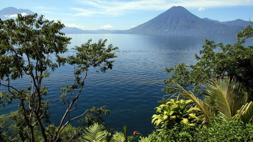 The edge of Lake Atitlan is dotted with towns and volcanoes.