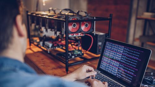 One man, sitting in his office, using computer for mining bitcoin. cryptocurrency crypto