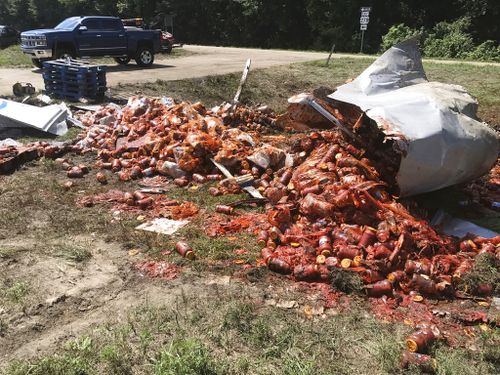 Broken jars of spaghetti sauce litter a road in Camden, Arkansas. (AP)
