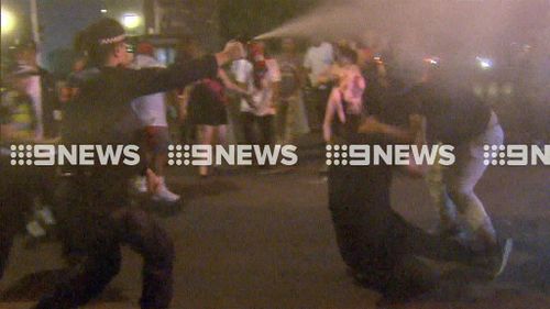 Police were forced to employ pepper spray as violence erupted. (9NEWS)