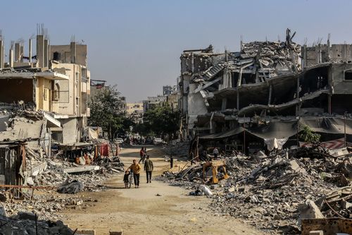 Palestinians are seen among the rubbles of demolished house as Palestinians try to continue their daily lives despite the destroyed buildings and difficult conditions in Khan Yunis, Gaza on November 15.