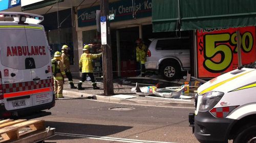 A teenager has been killed after a car crashed into a Sydney chemist. (Caitlin Barker, 9NEWS)