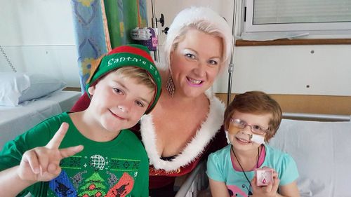 Mum and son visit children at Ipswich Hospital dressed as as 'Mrs Claus' and elf helper