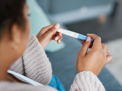 Woman looking at pregnancy test