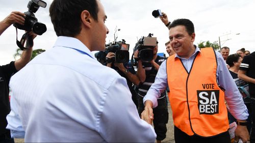 Nick Xenophon's awkward handshake with Hartley rival Vincent Tarzia on election day. (AAP)