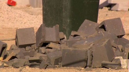 The workers was building a wall with concrete blocks when they collapsed and crushed him.