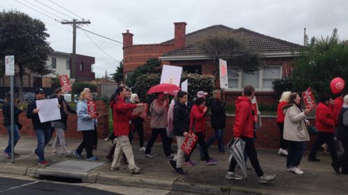 Hundreds march down Melbourne highway in protest of Sky Rail construction 