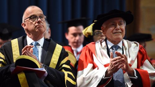 Former Australian Prime Minister John Howard seated beside Vice Chancellor Michael Spence. (AAP)