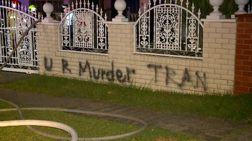 Graffiti was scrawled across the front fence of the large two-storey house. (9NEWS) 