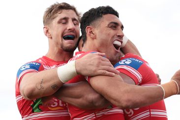 Zac Lomax and Tyrell Sloan celebrate a try with Dragons teammate Mat Feagai against the Raiders in 2023.