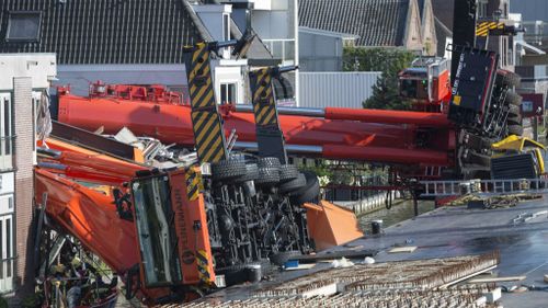 The two cranes lay on their sides after the accident in Alphen aan den Rijn. (AAP)