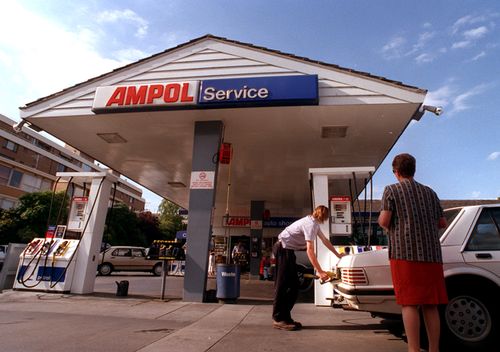 A man fills up his car in 1998 at the Ampol petrol station in Toorak, Melbourne.