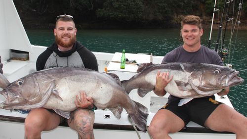 Josh Dugan and school friend catching fish.