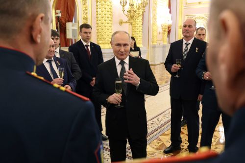 Russian President Vladimir Putin talks with awarded Russian servicemen after a ceremony to present Gold Star medals to Heroes of Russia on the eve of Heroes of the Fatherland Day at the St. George Hall of the Grand Kremlin Palace in Moscow, Russia, Friday, Dec. 8, 2023.
