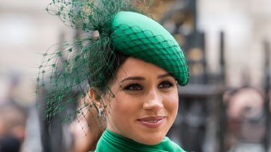 Meghan Markle smiling dressing in green