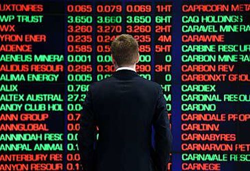 Man standing in front of ASX boards (AAP)