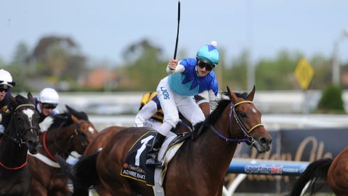 Jockey Zac Purton celebrates Admire Ratki's victory in Race 9 at the 2014 Caulfield Cup. (AAP)