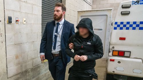 A man being arrested by NSW Police as part of Strike Force Sweetenham.