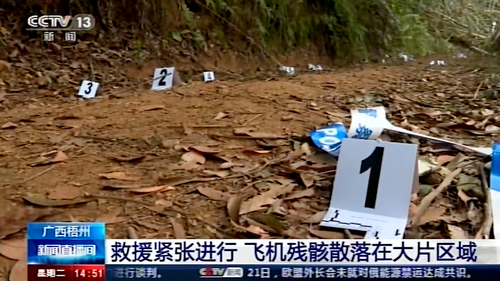 In this image taken from video footage run by China's CCTV, debris marked by numbers is seen at the site of a plane crash in Tengxian County in southern China's Guangxi Zhuang Autonomous Region, Tuesday, March 22, 2022. 