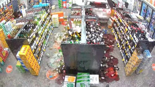 CCTV from inside the store shows the moment the car rams through the bottleshop. 