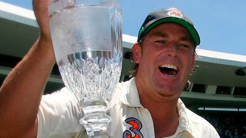 Australia's Shane Warne is carried around the field with the official Ashes Trophy
