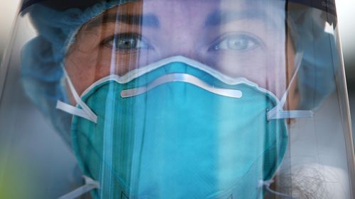 A registered nurse is seen wearing PPE at a Bondi Beach COVID-19 drive-through testing clinic, in Sydney, Australia.