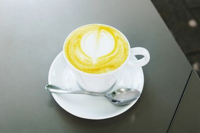 A mug with a yellow colored turmeric chai latte (Haldi ka doodh)