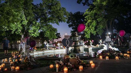 2022 年 5 月 27 日星期五，在德克萨斯州奥瓦尔第，本周在罗伯小学枪击案遇难者的城镇广场上的一个纪念地点在黎明时点起蜡烛。