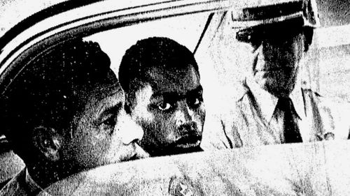 In this February 1964 file photo, Henry Montgomery, flanked by two deputies, awaits the verdict in his trial for the murder of Deputy Sheriff Charles H Hurt in Louisiana. (AAP)