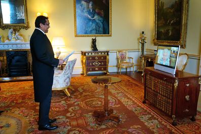 Queen Elizabeth appears on a screen via videolink from Windsor Castle, where she is in residence, during a virtual audience to receive the High Commissioner of Trinidad and Tobago, Vishnu Dhanpaul, at Buckingham Palace on March 3, 2022 in London, England.