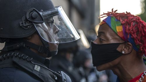 A protester confronts police during a rally in downtown Lexington, Kentucky, against the deaths of George Floyd and Breonna Taylor. 