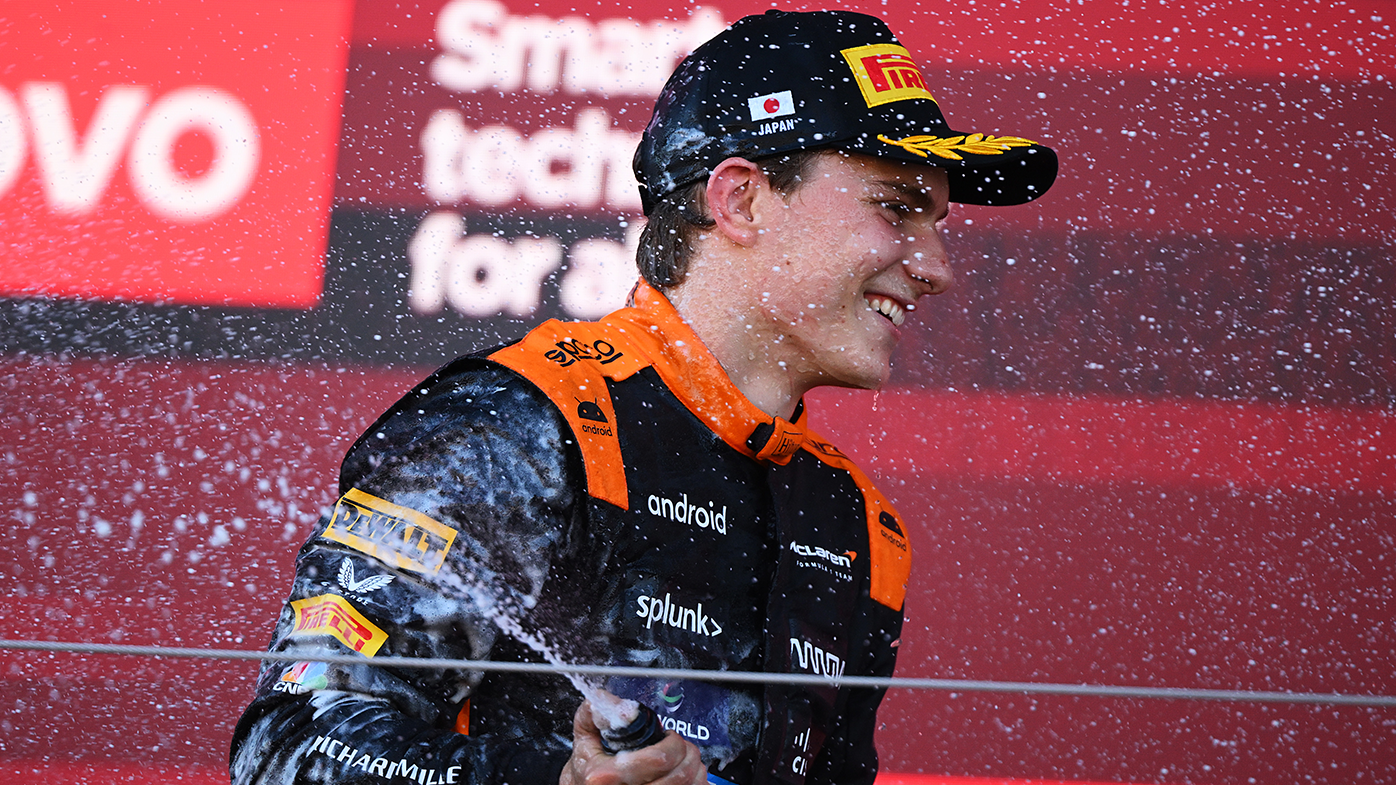 Oscar Piastri of Australia and McLaren celebrates his maiden podium after running third in the Japanese Grand Prix.