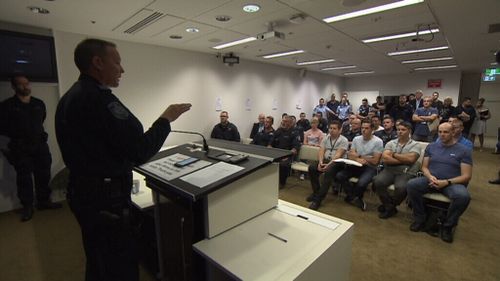 Officers get their instructions in the briefing room.