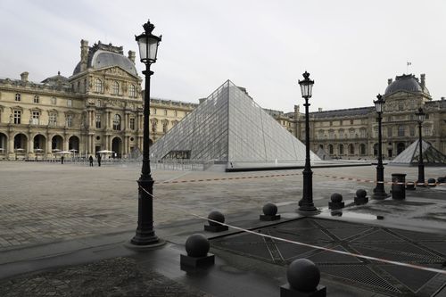 The almost empty courtyard of the Louvre museum is pictured Wednesday, Oct.14, 2020 in Paris. French President Emmanuel Macron is giving a nationally televised interview Wednesday night to speak about the virus, his first in months. French media reports say Macron will also step up efforts on social media to press the need for virus protections among young people. (AP Photo/Lewis Joly)