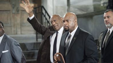 Bill Cosby waves to supporters. (AAP)