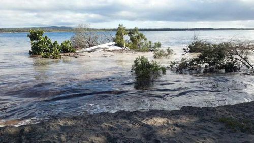 Sinkhole swallows car and caravan near Queensland beach