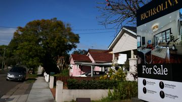 A real estate sign is seen at a property in Croydon Park in Sydney, Australia