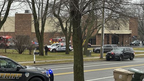 Emergency vehicles are parked outside the Abundant Life Christian School in Madison, Wis., where multiple injuries were reported following a shooting, Monday, Dec. 16, 2024. (AP Photo/Kathleen Foody)