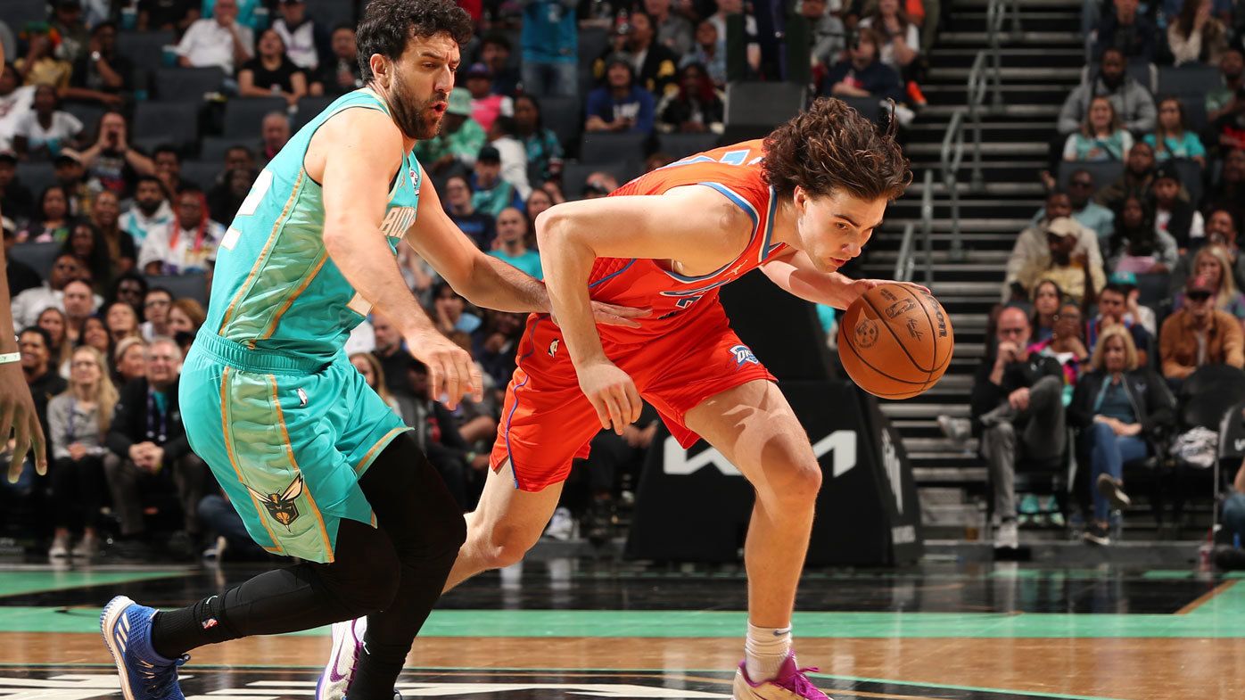 Josh Giddey dribbles past a Charlotte Hornets opponent.