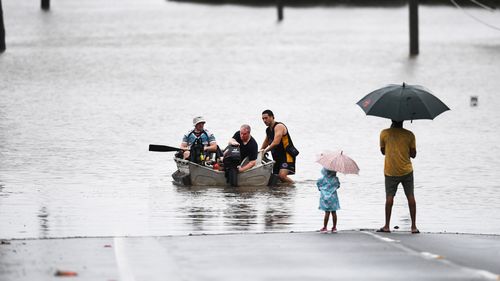 People in a boat in Logan, south of Brisbane.