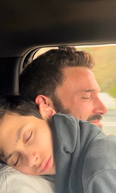 Ben Affleck cuddles Jennifer Lopez's son Max during Thanksgiving celebrations.