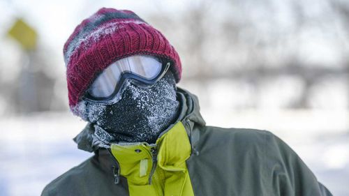 Authorities warn people should keep their faces covered while travelling outside, like this person in Minnesota.